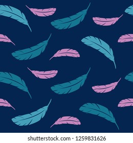 Feathers of a bird in flight. The flight feathers on a blue background. Colorful feathers of birds.