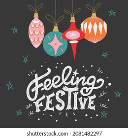 Feeling Festive lettering phrase decorated with doodle elements and hand drawn vintage Christmas balls and baubles. Great for invitation, holiday card, postcard, social media post, print.