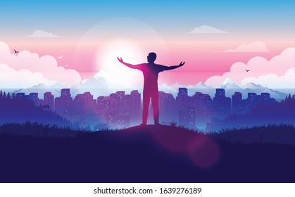 Feeling free - man standing on hill above city, with raised hands enjoying the freedom. Looking at the horizon with sunrise over cityscape, sky and clouds. Alone and happy. Embrace tomorrow concept.