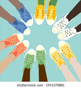 feet in colorful sneakers stand in a circle