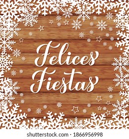 Felices Fiestas calligraphy hand lettering on wood background with snowflakes. Happy Holidays in Spanish. Christmas typography poster. Vector template for greeting card, banner, flyer, etc.