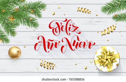 Feliz Ano Nuevo Spanish Happy New Year golden decoration and calligraphy font on white wooden background for greeting card. Vector Christmas gold shiny star on Xmas tree for winter holiday