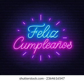 Feliz Cumpleanos neon lettering on brick wall background.