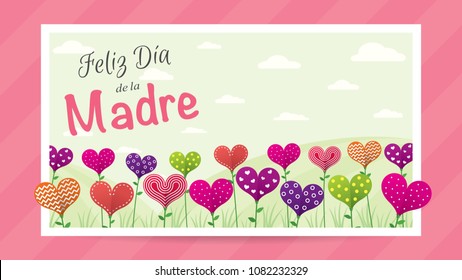 Feliz Dia de la Madre - Happy Mother's Day in Spanish language - greeting card. Field of flowers in the shape of a heart of different colors inside a white frame on a pink background. With copy space