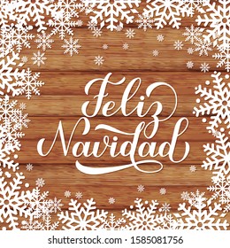 Feliz Navidad calligraphy hand lettering on wood background with snowflakes. Merry Christmas typography poster in Spanish. Easy to edit vector template for greeting card, banner, flyer, postcard.