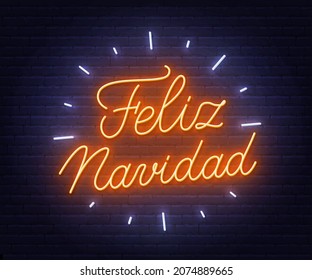 Feliz Navidad neon text. Greeting card on brick wall background.