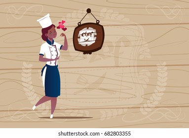 Female African American Chef Cook Happy Smiling Cartoon Chief In Restaurant Uniform Over Wooden Textured Background Flat Vector Illustration