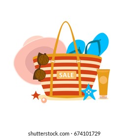 Female bag with beach accessories and sign 