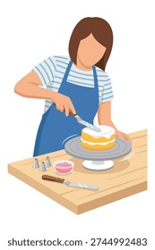 Female baker or confectioner decorating a yellow cake with white cream frosting using an offset spatula on a cake turntable.