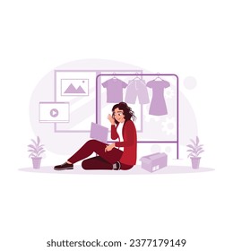 Female blogger sitting on the floor recording a video of a collection of clothes in a store. Blogger concept. trend modern vector flat illustration