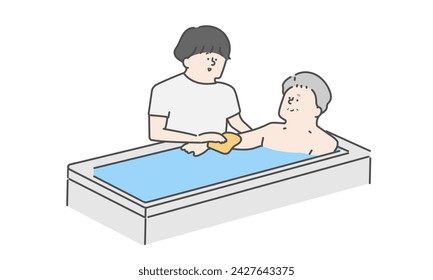 A female caregiver assisting an elderly man with bathing