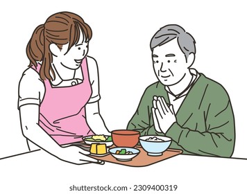 
Female caregiver and elderly man serving meals