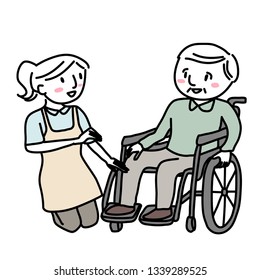 Female caregiver with elderly man in wheelchair. Senior man in wheelchair with caregiver. Elderly care service concept with smiling female caregiver taking care of happy elderly man in wheelchair.
