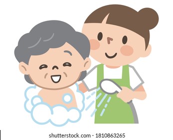 Female Caregiver Providing Bathing Assistance To Elderly Women