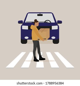 Female character with a box in her hands going along the pedestrian crossing in front of the car