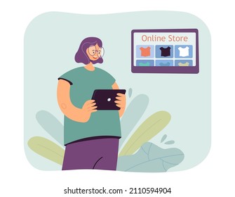 Female character holding tablet and choosing clothes in online store. Woman using app to buy T-shirt flat vector illustration. Online shopping concept for banner, website design or landing web page