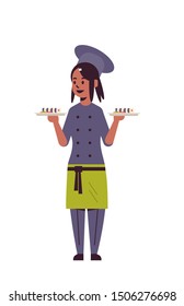 female chef cook holding trays with fresh sushi rolls african american woman restaurant kitchen worker in uniform carrying platter with japanese traditional food cooking concept full length vertical