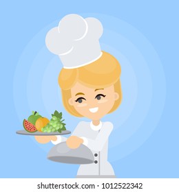 Female chef with fruit plate on blue background.