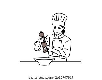 A female chef using a pepper mill