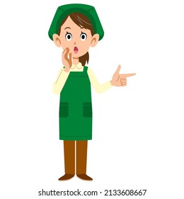 A female clerk in a supermarket pointing and whispering