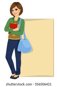 female college student with bag holding books and leaning against a blank board