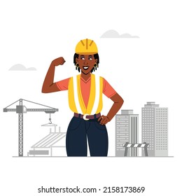 Female construction worker with dreadlocks in construction engineers uniform flexing elbow