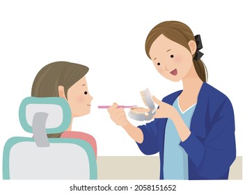 A female dental hygienist who teaches tooth brushing