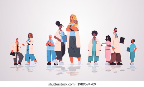 female doctor leader standing in front of mix race medical professionals team in uniform medicine healthcare