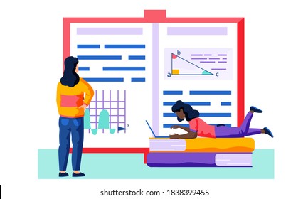 Female employee is lookingg at an unfolded book with text and various pictures of charts, graphs and diagrams. The woman is lying on two books and using her laptop to work at the computer. Working day