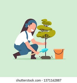 female farmer planting young tree gardener woman digging soil working in garden agricultural gardening concept flat full length