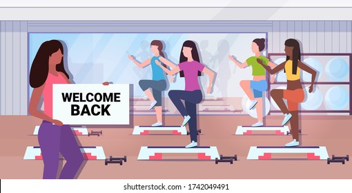 female fitness trainer holding welcome back sign board coronavirus quarantine is ending victory over covid-19 concept gym studio interior horizontal vector illustration