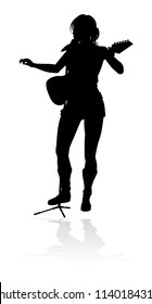 A female guitarist musician in detailed silhouette playing her guitar musical instrument.