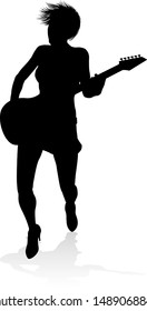 A female guitarist musician in detailed silhouette playing her guitar musical instrument.