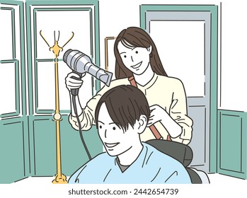 Female hairdresser drying a male customer's hair with a hair dryer