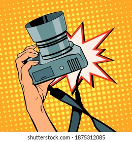 Female hand with a camera. Photographing in the studio. Vector isolated illustration in pop art style.