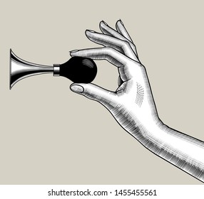 Female hand with a car horn in the fingers. Vintage engraving stylized drawing. Vector illustration