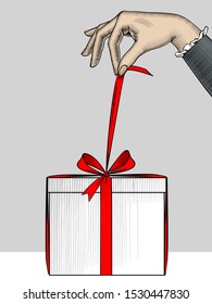 Female hand with Christmas gift. The hand untying the gift. Vintage engraving stylized drawing. Vector illustration