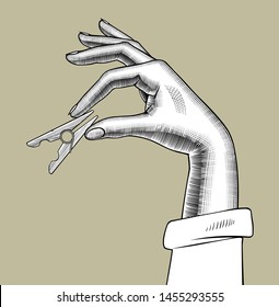 Female hand with a clothes pin in the fingers. Vintage engraving stylized drawing. Vector illustration