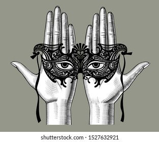 Female hand with a decorative carnival venetian mask with eyes cutted out of paper on the palms. Vintage engraving stylized drawing. Vector illustration