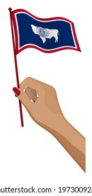 Female hand gently holds small flag of american state of Wyoming. Holiday design element. Cartoon vector on white background