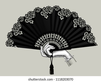 Female hand holding the black open fan with a tassel. Vintage engraving stylized drawing. Vector illustration