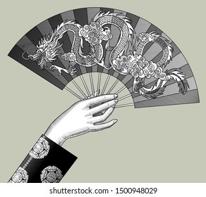 Female hand holding a Chinese fan with decorative gragon. Vintage engraving stylized drawing. Vector illustration