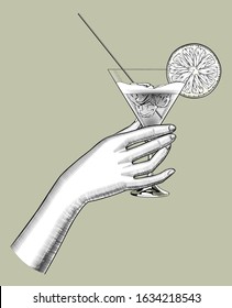 Female hand holding a cocktail with a orange slice and ices in the cone glass. Vintage engraving stylized drawing. Vector illustration