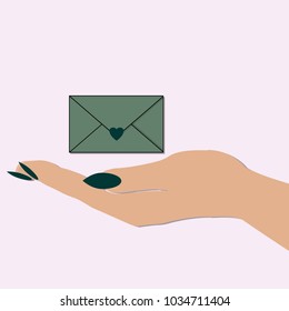 female hand holding an envelope