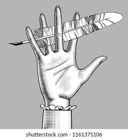 Female hand holding a feather pen. Retro design element. Vintage engraving stylized drawing. Vector illustration