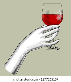 Female hand holding a glass with red wine. Vintage engraving stylized drawing. Vector illustration