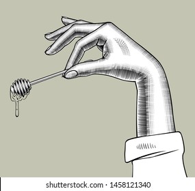 Female hand holding a honey dipper in the fingers. Vintage engraving stylized drawing. Vector illustration