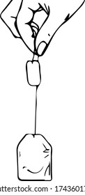 female hand holding a tea bag