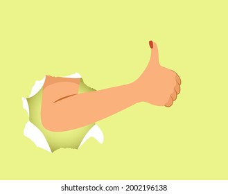 Female hand making thumb up like gesture through torn paper hole