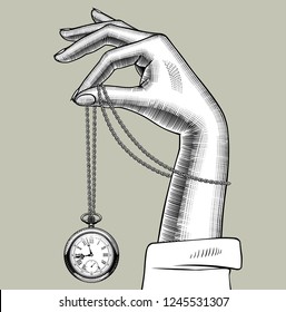 Female hand with a retro pocket watch on a chain. Vintage stylized drawing. Vector Illustration